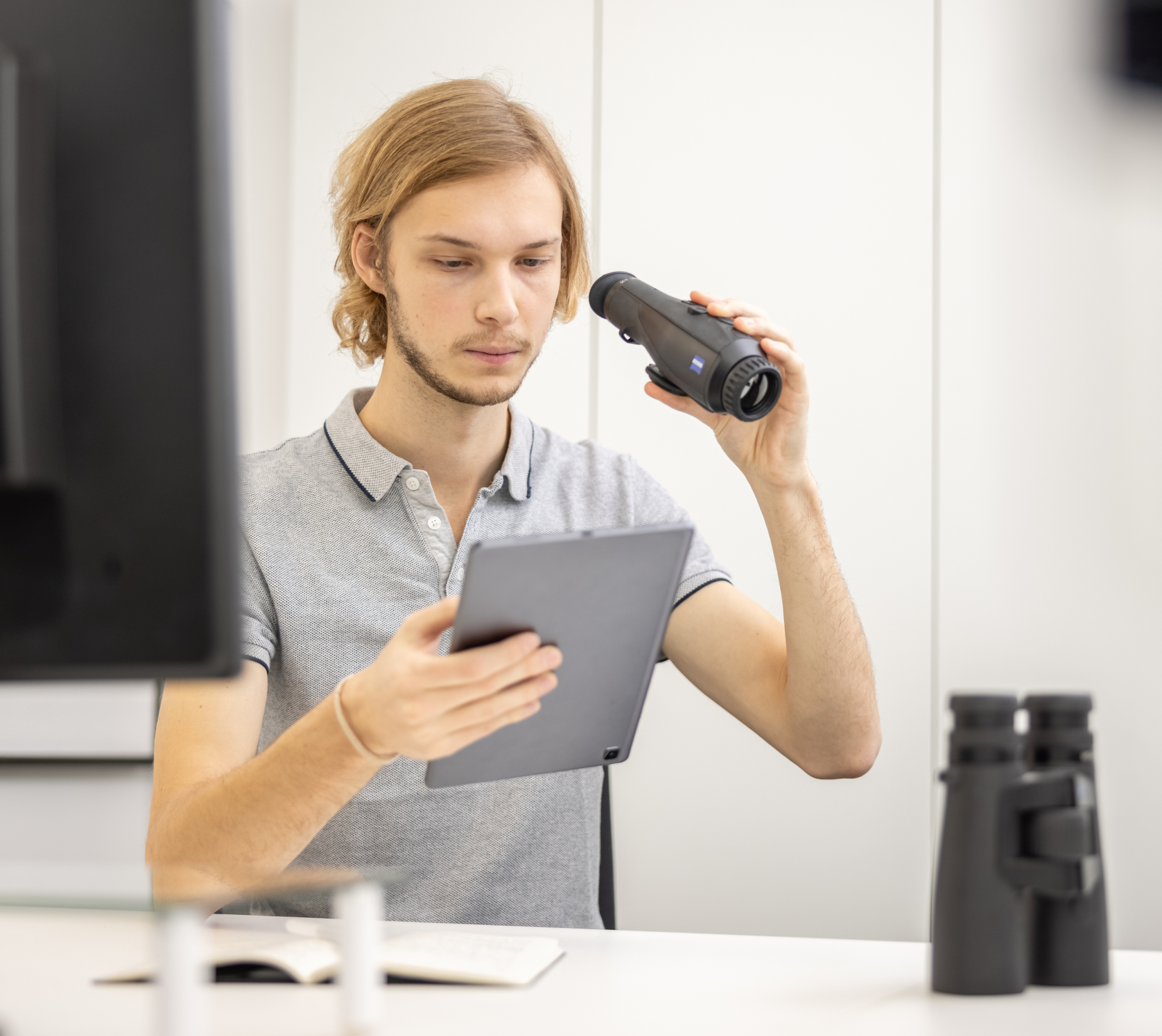 UX Testing: Mann mit Tablet und Fernrohr in der Hand